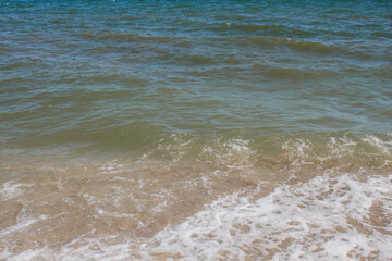 sea sandy beach against blue sky