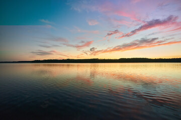 Sun sets over a lake in Mazury, Poland.