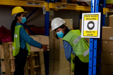 Caution sign in factory warning to industry labor worker to prevent Covid-19 Coronavirus spreading...