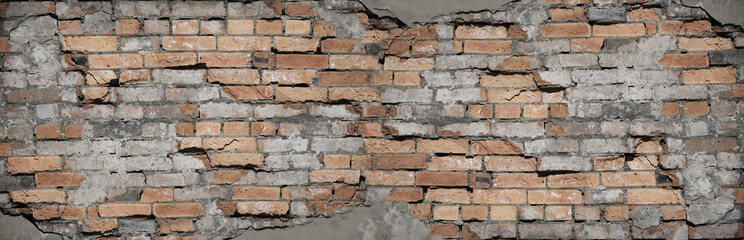 Brick grunge background. Old brick wall texture. Red brown brickwork with crumbling plaster.