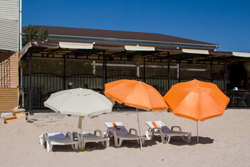 sun loungers with umbrellas on the beach
