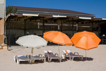 sun loungers with umbrellas on the beach