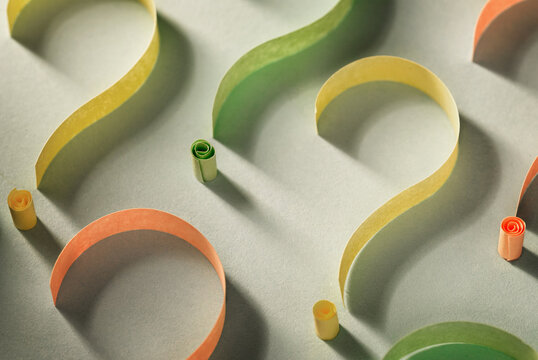 Colorful question marks of curled paper tape