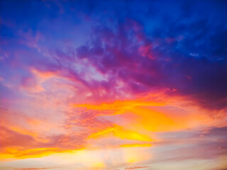 sunset sky with clouds explosion and golden light at ocean ,long exposure