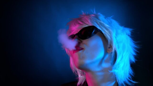 Super Slow Motion Shot of Blonde Girl Blowing Smoke at 1000 fps.