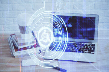 Double exposure of desktop computer and technology theme hologram. Concept of software development.