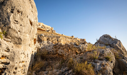 big boulders and a view to the medieval castle (Caliphate fortress) in Gormaz, province of Soria, Castile and Leon, Spain