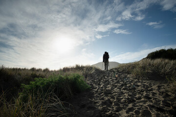 Fototapeta premium Walking on the black-sand Anawhata beach, Waitakere, New Zealand