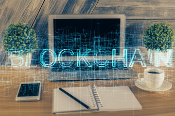Multi exposure of blockchain theme hologram and table with computer background. Concept of bitcoin...