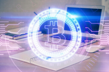 Multi exposure of blockchain theme hologram and table with computer background. Concept of bitcoin crypto currency.
