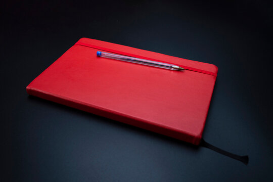 Red Notebook And Pen