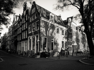 Amsterdam, Holland, the Netherlands - July 6 2020: capture of the typical Amsterdam scenery in black and white with canal, canalo house, clouds and the iconic buildings of the city
