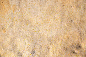 detail of a beige grainy cement wall background 