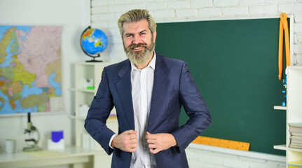 Back to school. Emotional bearded man in classroom chalkboard. Teaching with interest. Verify achieved learning outcomes. Teacher school lesson. Study and education. Modern school. Knowledge day