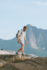 Man tourist hiking solo traveling in Norway vacations eco tourism in mountains outdoor adventure...