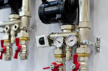 Close up of house heating system with many steel pipes, manometers, pump and metal tubes.