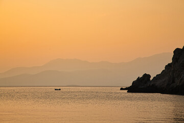 Fisherman Boat on sea during golden sunset, Greece