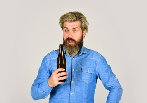 Adding a joy in Life. mature man drink beer. healthy water in glass bottle. brutal hipster drinking alcohol beverage. beer and football. relax after work day. lets have fun. bearded man has hangover