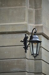 Old black lantern on a sandstone wall in the city of Zurich Switzerland