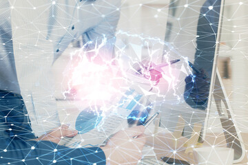 Man with computer background with brain theme hologram. Concept of brainstorm. Double exposure.