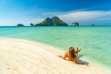 Fototapeta na wymiar Woman on the Thai beach of Railay in Krabi