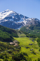 Fototapeta premium The pastures, the mountains and the nature while hiking above the village of Madesimo, Italy - June 2020.