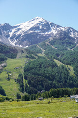 Obraz premium The pastures, the mountains and the nature while hiking above the village of Madesimo, Italy - June 2020.