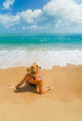 Fototapeta na wymiar Woman relaxing on the beach