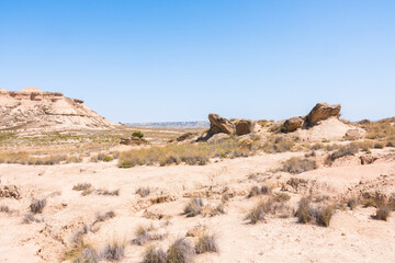 Fototapeta na wymiar Las Bardenas Reales on a sunny day. Semi-desert natural region, or badlands in southeast Navarre (Spain). Compared to Arizona in the United States of America. No people. Into the wild.