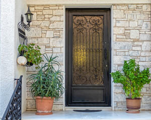 contemporary house entrance metal and glass door and potted plants, Athens Greece