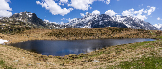 A lake during the summer in the Italian Alps, near the town of Madesimo, Italy - June 2020.