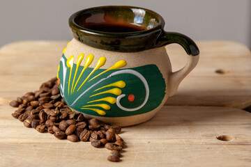Mexican coffee mug with coffee beans on wooden plate