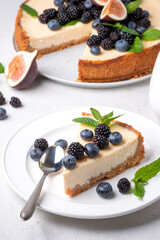 Set of cheesecakes with fresh berries and mint  on gray background 