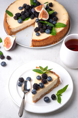 Set of cheesecakes with fresh berries and mint  on gray background 