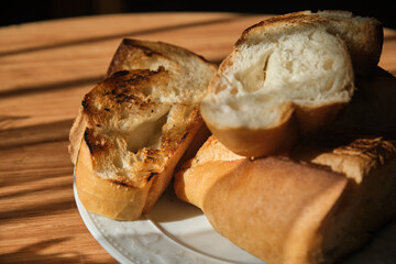 Roasted bread slices on wooden table