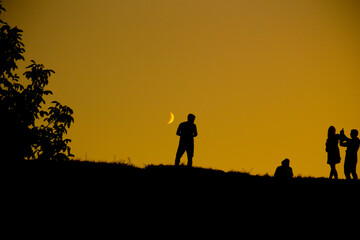 Fototapeta na wymiar Silhouette of a group of people against the sky