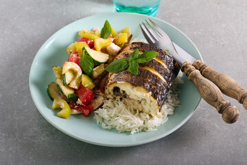 Baked sea bass fish on top of the rice