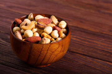 Fototapeta na wymiar Nut mix in a wooden bowl