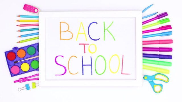 Frame with back to school title appear and school stationery appear under it on white theme. Stop motion 