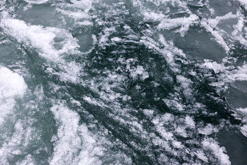 Fototapeta na wymiar Sea covered with broken ice. Front focus. Black sea in winter