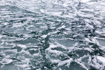 Sea covered with broken ice. Front focus. Black sea in winter