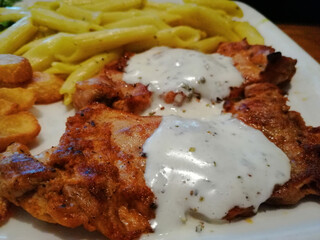Chicken, rice and salad on a serving plate