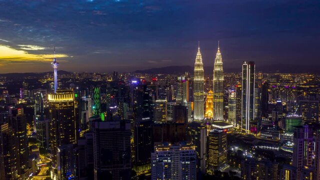 Kuala Lumpur, Malaysia - August 4, 2020: Aerial drone time lapse of sunset scene at Kuala Lumpur city skyline. Clip may have noise due to high ISO. 