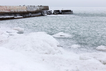 Sea covered with broken ice. Front focus. Black sea in winter