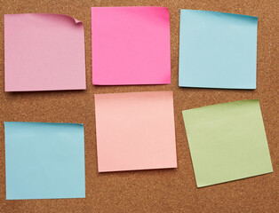 colorful paper stickers glued on brown balsa board, idea and multitasking