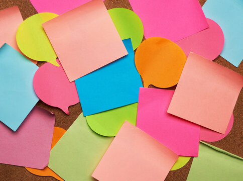 colorful paper stickers glued on brown balsa board, idea and multitasking