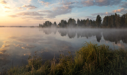 Fototapeta na wymiar morning landscape on the shore of the Ural lake with fog, Russia, Ural, August