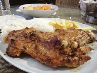 Chicken, rice and salad on a serving plate