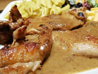 Chicken, rice and salad on a serving plate