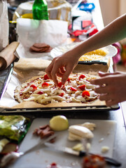 Obraz na płótnie Canvas Making pizza in domestic kitchen